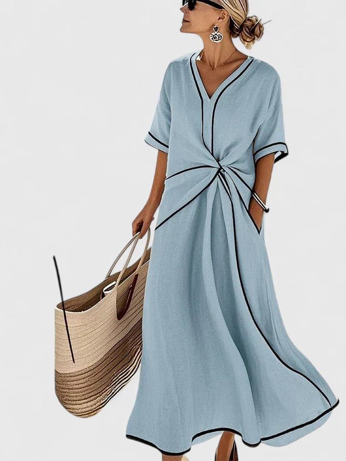 Elegant summer dress featuring vertical stripes, designed for a lightweight and breathable feel, perfect for warm weather occasions. 0
